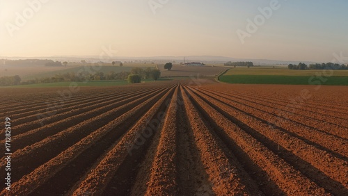 Wide-angle shot of plowed earth ready for spring sowing with visible furrow patterns