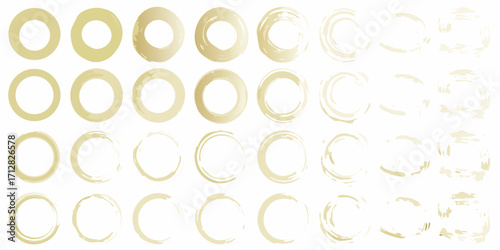 Collection of abstract golden brush stroke circles and rings on a white background