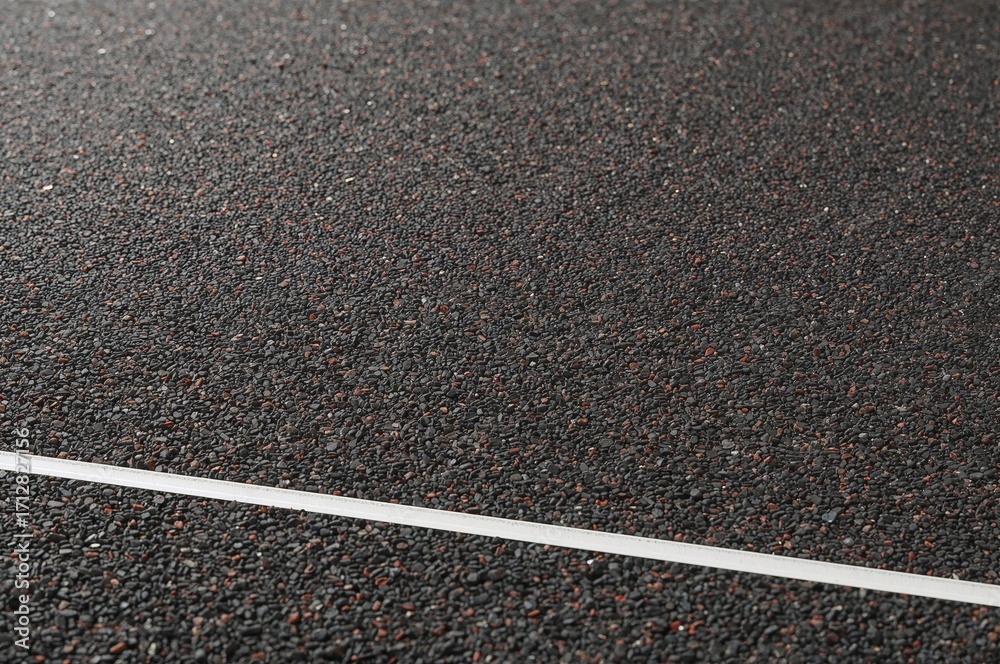 Fototapeta premium Rubber granule-filled cushioned flooring. Unique rubber surface designed for athletic use