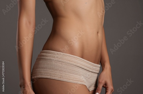 Close-up shot focusing on the slender midsection of a beautiful woman.