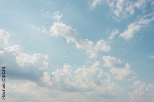 Wide-angle shot capturing a bright, windy sky with blue hues, resembling a cloudy day in spring or summer.