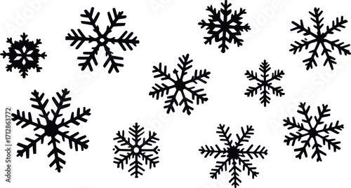 A collection of black snowflake shapes scattered on a white background creating a wintery design style