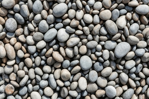Close-up of smooth, rounded stones surface. Detailed pebbles texture. High-resolution image.
