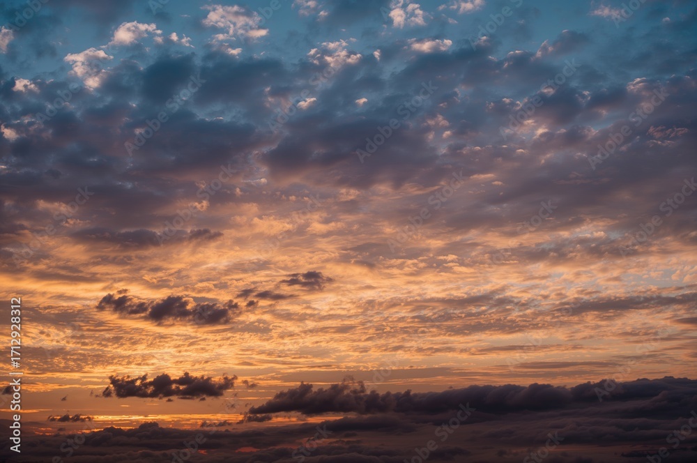 Fototapeta premium Wide-angle perspective of a sunset with golden and blue hues in a natural setting
