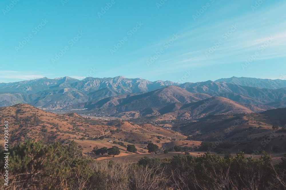 Fototapeta premium Scenic panorama of mountain ranges from a high forest trail