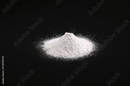 Talc powder against a dark ...