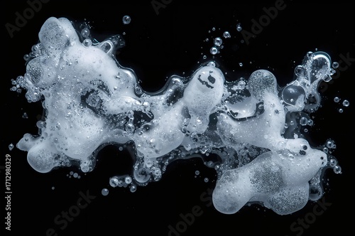 Overhead perspective of white soapy foam with abstract bubbles on a dark backdrop