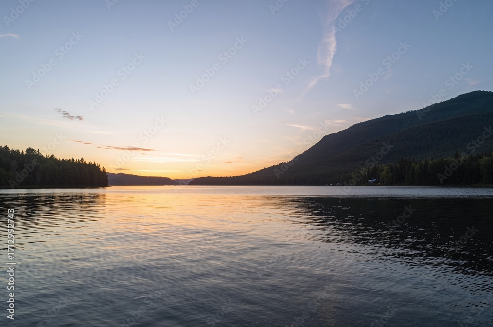 Fototapeta premium Sunset over a peaceful mountain lake