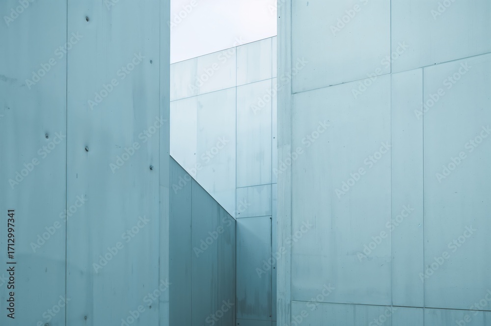 Fototapeta premium Architectural close-up of a modern cement facade featuring diverse geometric patterns in soft blue shades with interplay of light and shadow, minimalist style.