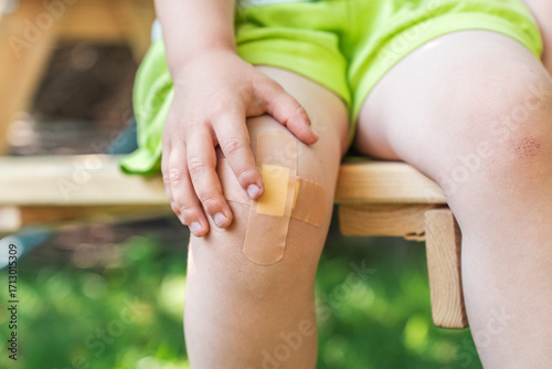Little child with Band-Aid on her knee