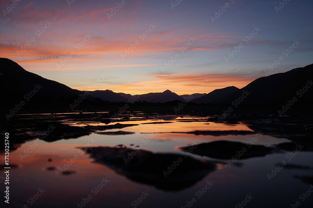 Fototapeta premium Mountain range sunset silhouette scene