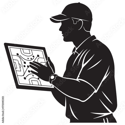 Silhouette of a Sports Coach Analyzing Game Strategy on a Digital Tablet