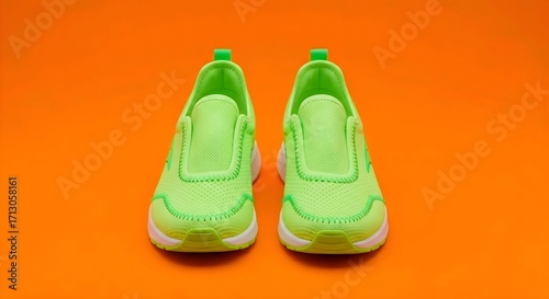 Lime green sneakers with white soles on vibrant orange background. Key elements: shoes' neon color, contrast with background. Bright, playful atmosphere. AI Generated