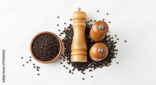 Natural Wood Pepper Mill, Shakers, and Bowl of Black Peppercorns in a Minimalist Top-Down Flat Lay.