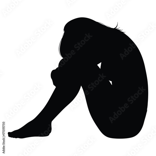 A solitary figure curled up in a seated melancholic pose silhouette