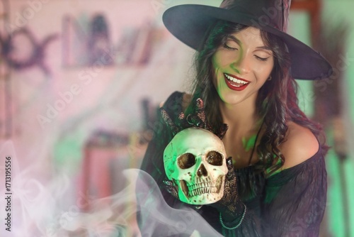 Young witch with skull at home