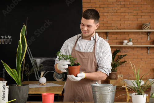 Young male gardener in gard...