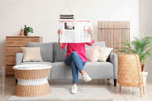 Woman with newspaper sittin...
