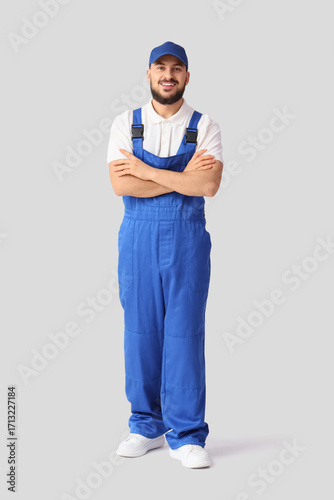 Male worker smiling on whit...