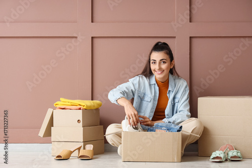 Young woman packing wardrob...