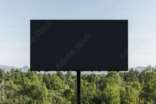 Wallpaper Mural A large empty billboard stands above a green treeline against a clear blue sky, inviting attention and future messaging in outdoor advertising. Torontodigital.ca