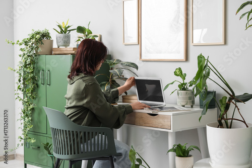 Young woman with laptop and...
