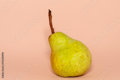 pear on a plain peach, pink background