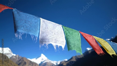 Colorful Prayer Flags Fluttering Against a Majestic Mountain Backdrop.