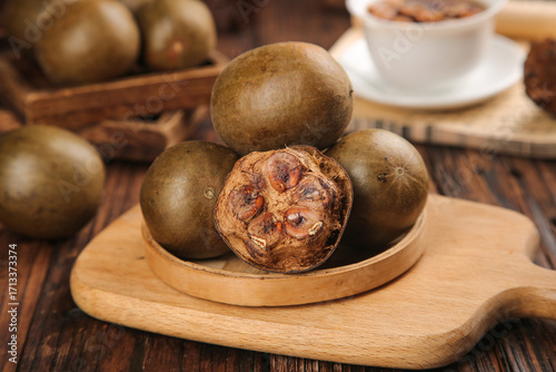 Luo Han Guo Monk Fruit from Guilin Guangxi China - Traditional Roasted Medicinal Herbs for Moisturizing and Lung Health on Wooden Board