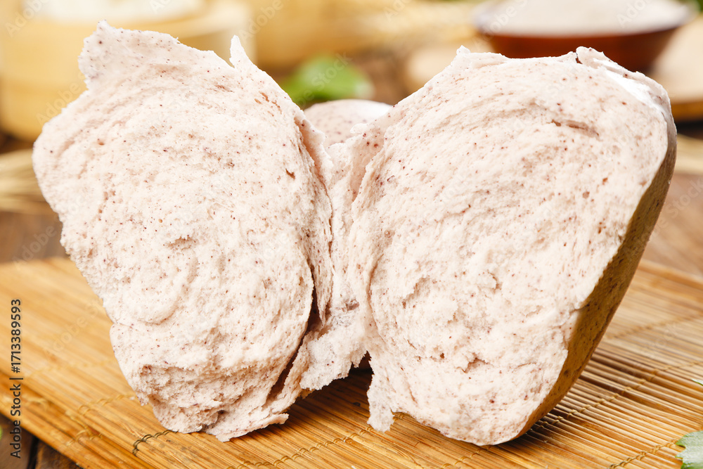Fototapeta premium Buckwheat bread buns split on wooden board - healthy whole grain bakery stock photo