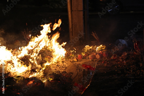 Chinese hungry ghost festival burning joss stick candle joss fake paper money flame fire smoke ash