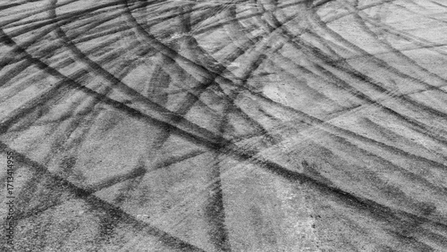 Black tire marks on road, Black rubber tire marks and tread marks, Tire trace track wheels texture and background, Auto tire tread grunge, Car wheel tyre tread track black tyre print.