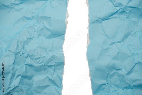 Torn blue textured paper reveals bright white abstract space and grungy background