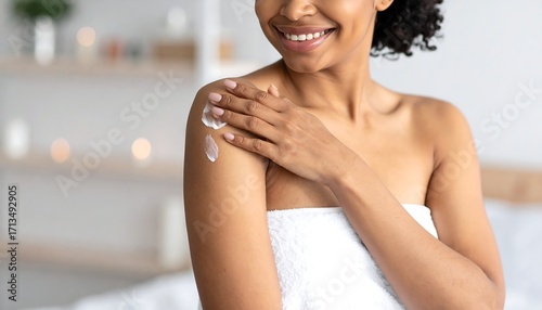 Woman applying cream to shoulder