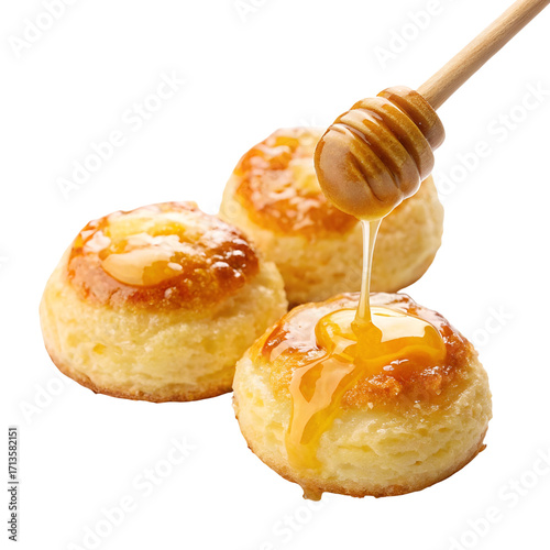 Honey Dripping Onto Three Round Sweet Pastries With Honey Dipper pouring