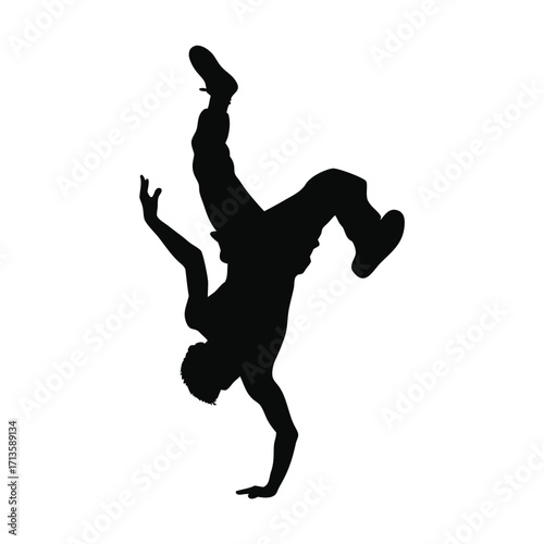 Silhouette of a dancer performing a dynamic handstand breakdance move