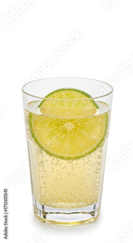 Wallpaper Mural A refreshing glass of lime soda beverage, showcasing a vibrant lime slice atop bubbly, light yellow liquid. Torontodigital.ca