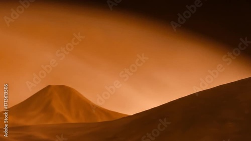 Arid landscape of dust hills under a hazy orange sky