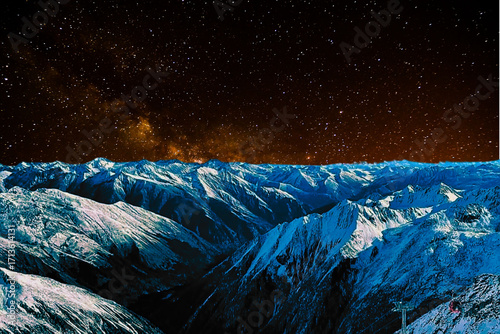 night view of snowy mountain range and milky way. starry night sky with stars and moon. beautiful landscape with snowy mountain peaks in winter night.