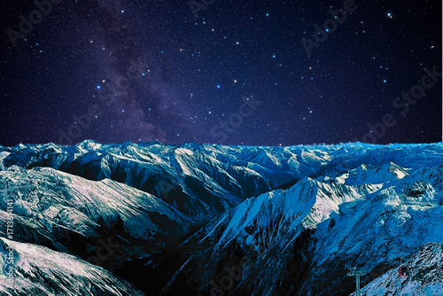 night view of snowy mountain range and milky way. starry night sky with stars and moon. beautiful landscape with snowy mountain peaks in winter night.