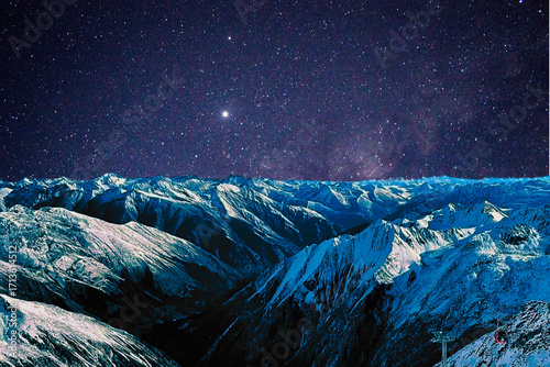 night view of snowy mountain range and milky way. starry night sky with stars and moon. beautiful landscape with snowy mountain peaks in winter night.