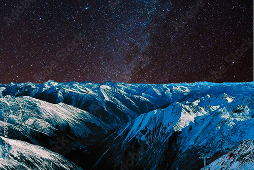 night view of snowy mountain range and milky way. starry night sky with stars and moon. beautiful landscape with snowy mountain peaks in winter night.