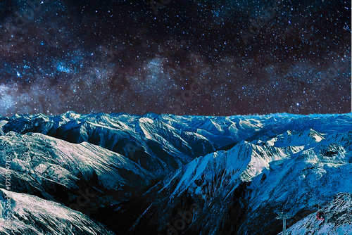 night view of snowy mountain range and milky way. starry night sky with stars and moon. beautiful landscape with snowy mountain peaks in winter night.
