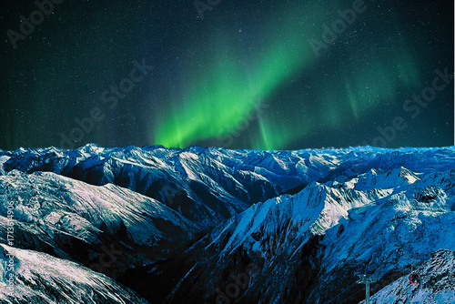 night view of snowy mountain range and milky way. starry night sky with stars and moon. beautiful landscape with snowy mountain peaks in winter night.