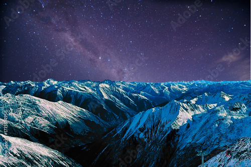 night view of snowy mountain range and milky way. starry night sky with stars and moon. beautiful landscape with snowy mountain peaks in winter night.