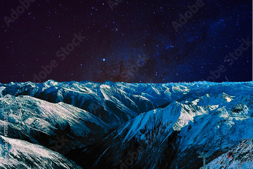 night view of snowy mountain range and milky way. starry night sky with stars and moon. beautiful landscape with snowy mountain peaks in winter night.