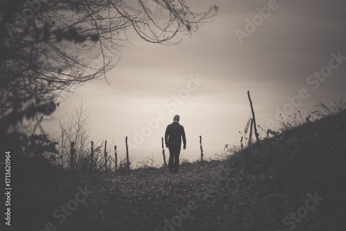 Man walking in a foggy autumn landscape