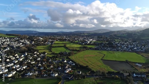 Panoramic view of village, fields, & distant hills