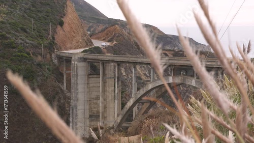 footage of the iconic Bixby Creek Bridge spanning Highway 1 along the dramatic cliffs of Big Sur, California