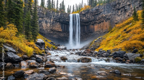 Autumn Waterfall Cascading Over Rocky Gorge